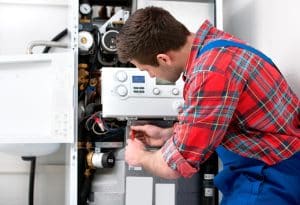 Technician servicing gas boiler